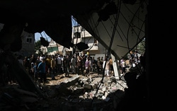 イスラエルによる空爆で破壊された家に集まる人々（ガザ地区）