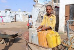 紛争から逃れ難民キャンプで家族と暮らす13歳のモハメッドくん。毎朝タンクに水を汲んでいる。(イエメン、2020年4月7日撮影)