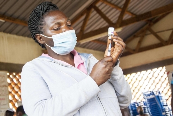 マサカ地方にある病院で、COVID-19ワクチンを注射器に注入し予防接種の準備をする看護師。(ウガンダ、2021年10月19日撮影)