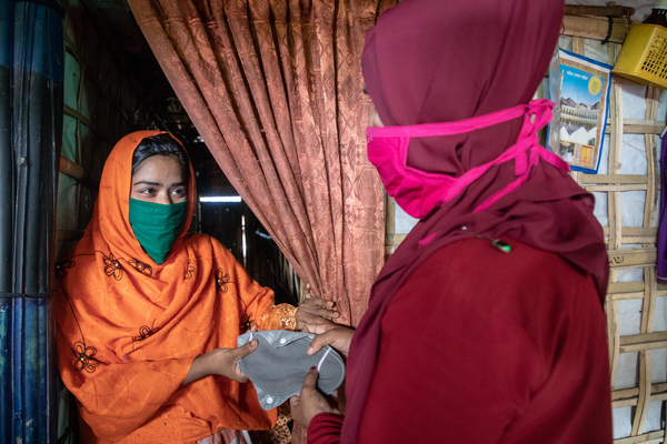 ロヒンギャ難民キャンプでユニセフが展開している月経衛生管理プログラムの一環で、支援物資の生理用ナプキンを受け取るマリウムさん(20歳)。(バングラデシュ、2021年9月撮影)