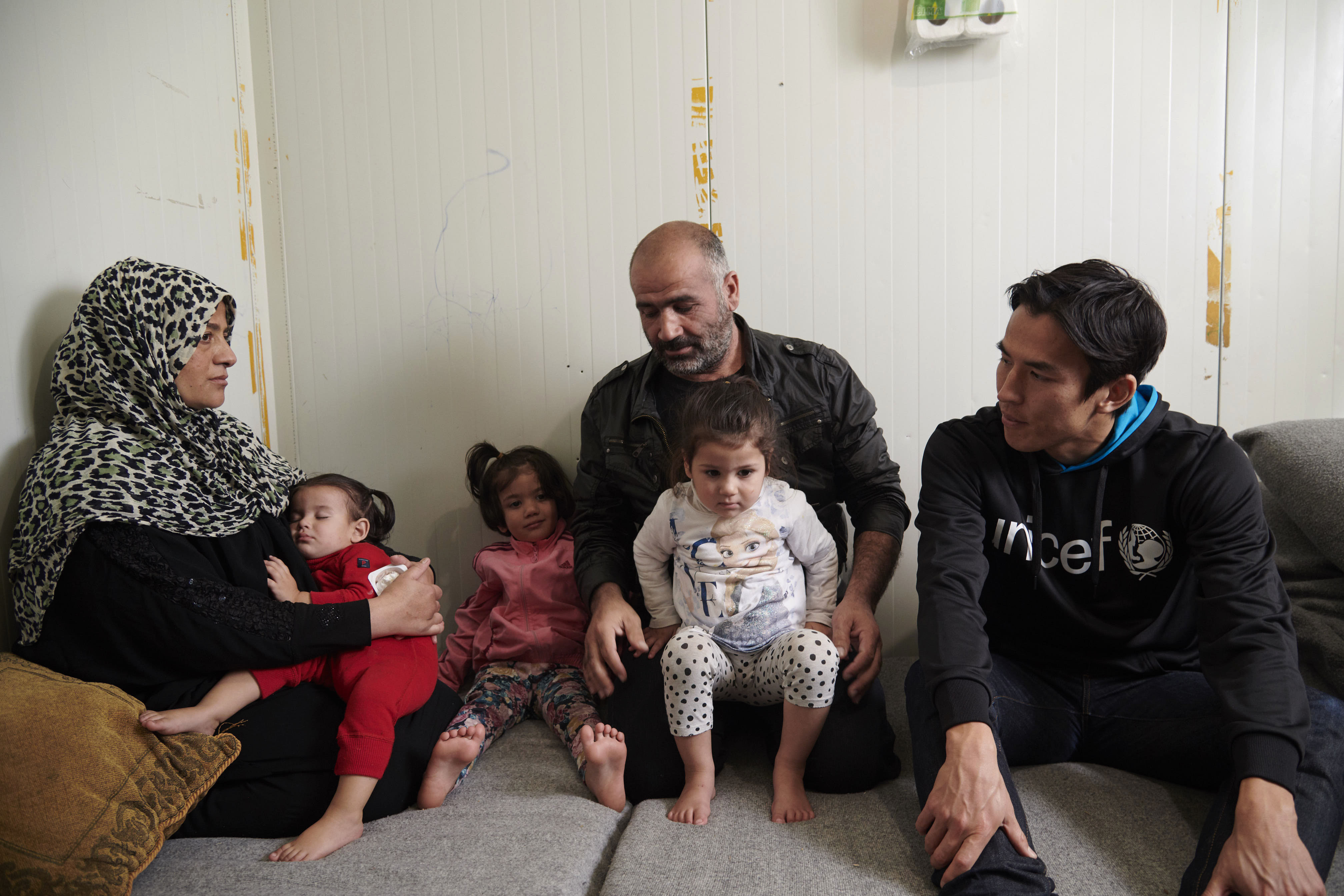 2018年にギリシャのエスカラマンガス難民キャンプを訪れた時、タレックさんの両親から、シリアからギリシャに逃れて来た時の様子を聞く長谷部大使。(ギリシャ、2018年11月撮影)