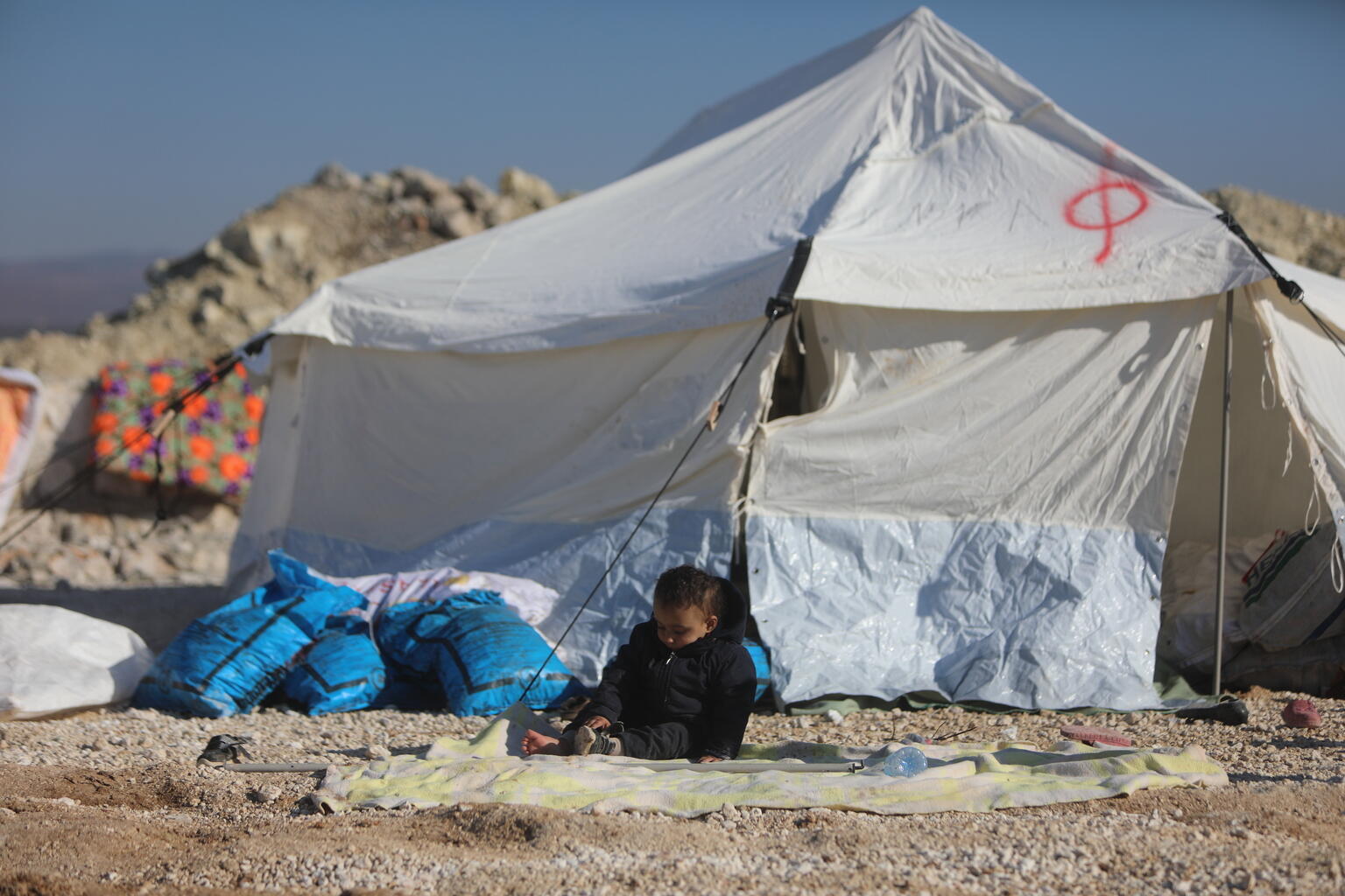 地震被災者のためのテントで暮らす子ども。多くの子どもは、平和なシリアを知りません。