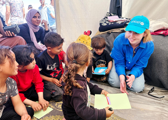 避難民キャンプで、ユニセフが支援する心のケアを受ける子どもたちと話すユニセフ広報官のテス・イングラム。(ガザ地区、2024年4月3日撮影)