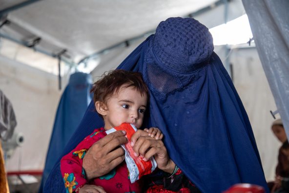 避難民キャンプの診療所で、重度の急性栄養不良と診断され、すぐに食べられる栄養治療食（RUTF）を口にする生後18カ月のサフィアちゃん（アフガニスタン、2025年9月27日撮影）