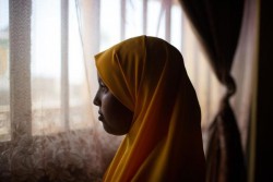 Bilen Yusuf, 12, poses for a photograph in her home in Gursum Woreda, Bombass district (Kebele), Somali Region, Ethiopia, 23 January 2015. Biden went through a Female Genital Mutilation (FGM) type known as Sunna-circumcision, last year which led to her mother being sued by the woreda Bureau of Women, Children and Youth Affairs (BOWCYA) for arranging the act without notifying the office. Though FGM is illegal by law, Sunna-circumcision still takes place in the Somali region because it is considered as a religious requirement by many. It is however, monitored by people from the BOWCYA office so that the circumcisers, upon the request of parents, would not cut to low or attempt Pharaonic circumcision, which is a very severe form of FGM. Pharaonic circumcision or infibulation, refers to the removal of all external genitalia and the sewing of the remaining parts of outer lips, only leaving a small hole for urine and menstrual flow, whereas Sunna-circumcision is the excision of all or part of the clitoris. Bilen says that she asked her mother to arrange it for her, because she did not want to be any different from her peers.