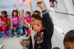 ベッカー高原の非公式居住区内の学校の授業に参加するシリア難民の子どもたち。