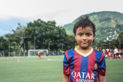 エルサルバドルの地元スタジアムでサッカーをする男の子。