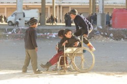 アレッポ市郊外のジブリーンで置き去りにされた車椅子を使って遊ぶ子どもたち(2016年12月7日撮影)