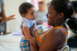 母親教室で、赤ちゃんを抱きあげ笑いかける若い母親。 (セントクリストファー・ネイビス)2017年7月12日撮影
