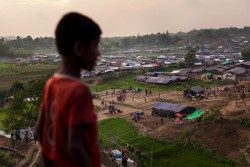 On 6 September 2017, a boy stands on a hill in the Kutupalong makeshift settlement for Rohingya refugees in Ukhiya, a sub-district of Cox's Bazar District, Bangladesh. By 5 September 2017, more than 146,000 Rohingya refugees fled across the border from Rakhine State, Myanmar, into Cox's Bazar district, Chittagong Division in Bangladesh since 25 August. As many as 80 per cent of the new arrivals are women and children. More than 70 000 children need urgent humanitarian assistance. More than 100,000 of the newly arrived refugees are currently residing in makeshift settlements and official refugee camps that are extremely overcrowded while 10,000 newly arrived refugees are in host communities. In addition, 33,000 arrivals are in new spontaneous sites, which are quickly expanding.  While some refugees are making their own shelters, the majority of people are staying in the open, suffering from exhaustion, sickness and hunger. Cox’s Bazar district of Bangladesh is one of the most vulnerable districts, not only for its poor performance in child related indicators but also for its vulnerability to natural hazards.  Most people walked 50 or 60 kilometers for up to six days and are in dire need of food, water and protection. Many children are suffering from cold fever as they are drenched in rain and lack additional clothes. Children and adolescents, especially girls, are vulnerable to trafficking as different child trafficking groups are active in the region. Many more children in need of support and protection remain in the areas of northern Rakhine State that have been wracked by violence. In Bangladesh, UNICEF is scaling up its response to provide refugee children with protection, nutrition, health, water and sanitation support. With the recent influx of refugees, demand has increased and UNICEF is working to mobilize more support and strengthen its existing activities. For recreational and psychosocial support to the newly arrived Rohingya children, 33 mobile Chil