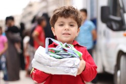 A child carries nutritional supplements which he received after being examined by health workers at a mobile health clinic in the Al-Hilwanieh neighbourhood of eastern Aleppo, Syrian Arab Republic, Wednesday 14 June 2017. With no functioning public health centers in eastern Aleppo as of July 2017 and little cash among families who are returning to pay for private healthcare, UNICEF-supported mobile health clinics provide essential primary health services free of charge. Every day at nine in the morning, 25 health workers in seven trucks start their journey through the streets of east Aleppo. In order to reach as many people as possible, the trucks park close to crowded bread distribution points. The seven clinics-on-wheels treat more than 400 children and women every day for common illnesses, providing medicine and immunization services, as well as micronutrients and nutritional supplements to treat and prevent malnutrition.  “The most common cases we see are related to malnutrition, diarrhoea and water-borne diseases,” says Dr. Kamal who works in one of the UNICEF-supported mobile clinics. “Living amidst the rubble, combined with a general lack of safe water, means hygiene conditions in the area have worsened, causing more children to fall ill,” he added. As more people return to the area, there is increasing demand for health services. “Although we come here every day for 6 hours, we barely stop work for one minute. We see one child or mother every 10 minutes while dozens of others are lining up outside in the scorching heat,” said Siba, a nurse at one of the clinics. To help prevent malnutrition, a team of community volunteers also accompanies the mobile health clinic, passing on information to mothers and answering questions on how to provide more nutritious diets for their young children. “During one-on-one sessions with mothers, we hear all kinds of dreadful stories. Many women have lost their husbands and are facing the world alone,” s