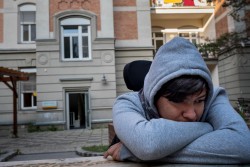 Sajad Al-Faraji, 16,  sits at a refugee housing center in a former abandoned seniors hospital in Heitzing, a suburb of Vienna, Austria on September 7, 2017. By late November 2015, refugee and migrant flows into Europe remained at an unprecedented high. Since the beginning of the year, over 870,000 refugees and migrants have crossed the Mediterranean Sea to Europe. Many of them are escaping conflict and insecurity in their home countries of Afghanistan, Iraq, Pakistan and the Syrian Arab Republic. More than one in five is a child.  Sajad Al-Faraji, 16, who fled conflict in Basra, Iraq with his brother, Zein Alabdien Al-Faraji, 14, his sister, Houda Al-Malik 26, and his mother Mona Al-Hammoudi, 56, lost the use of his legs during an operation on his lower back when he was one month old in Iraq. His family arrived in Vienna in late 2015 after a harrowing trip through the Balkans.  A year after arriving in Austria, Sajad was accepted into a school.  In September 2017, the family are still waiting for an interview from the authorities to begin their asylum process in Austria. Sajad is deeply frustrated, and as an escape, he spends between two and three hours a day playing games on his phone. “I didn’t know about Europe, but now I’ve met so many people, and seen many things, and I’m one step closer to my dreams. My dream now is to finish school and learn very good German. I want to be with the Austrian people, I want to work as a chef, I want to travel.” Sajad said, pausing, “I want to have a life like others.” Please see the series noted below for photo documentation of Sajad over the two-year period: 2015 - https://weshare.unicef.org/Folder/2AMZIF3TGC6  2016 - https://weshare.unicef.org/Folder/2AMZIFIPAIS1  2017 - https://weshare.unicef.org/Folder/2AMZIFIPAB32