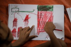 A Rohingya child works on a drawing depicting a helicopter attacking homes at a Child-Friendly Space in Balukhali refugee camp, Cox's Bazaar, Bangladesh, Sunday 29 October 2017. As at 20 October 2017, well over half a million Rohingya people have crossed into Bangladesh’s southern district of Cox’s Bazar since late August after escaping horrific violence in neighbouring Myanmar. They have joined some 200,000 others who came in earlier refugee influxes. Almost 60 per cent of the latest arrivals are children, crossing at a rate of between 1,200 and 1,800 per day.  High levels of severe acute malnutrition among young children have been found in the camps, and antenatal services to mothers and babies are lacking. Support for children traumatised by violence also needs to be expanded. Expanding the provision of safe water, sanitation and improved hygiene for Rohingya children is the top priority, amid concerns over a possible outbreak of diarrhoea and other waterborne diseases. Most Rohingya children are not fully immunized against diseases such as measles. UNICEF is also focused on providing Rohingya children with learning and support services in child-friendly spaces, and working with our partners to address gender-based violence. UNICEF is calling for an end to the atrocities targeting civilians in Myanmar’s Rakhine State, and for humanitarian actors to be given immediate and unfettered access to all children affected by the violence there.  At present, UNICEF has no access to Rohingya children in Northern Rakhine State. At the end of September 2017, UNICEF announced that it is planning to establish more than 1,300 new learning centres for Rohingya children who have fled Myanmar to neighbouring Bangladesh. UNICEF is running 182 learning centres in Rohingya camps and makeshift settlements in Cox’s Bazar, and has enrolled 15,000 children. It plans to increase the number of learning centres to 1,500, to reach 200,000 children over the next year. The learning c