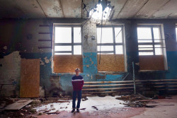 Oleksandr, 16 years old, is photographed in a gym of School in Troitske Luhansk region, that was directly hit by a shell. The gym is now used as a storage room.