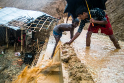 On 10 June 2018 in Bangladesh, Rohingya refugee children struggle with the mud collecting on a retaining wall during the first days of monsoon rain in Kutupalong Camp, Cox's Bazar.  Much of the infrastructure of the camps is eroding as the rain falls. Deforestation has left the sandy ground unstable. Since an outbreak of violence began on 25 August 2017, approximately two thirds of a million Rohingya people have sought refuge in neighboring Bangladesh. More than half of them are children. UNICEF and partners are working to provide for the needs of this enormous refugee population who are all the more vulnerable during the rainy season. During the monsoon season, which lasts from June to September, the overall health and wellbeing of Rohingya refugee children is affected. Increase risk of infectious disease, poor water and sanitation hygiene, and injury impact children whose immune systems are already weakened by acute malnutrition. In May 2018, UNICEF estimated that more than 100,000 people, including approximately 55,000 children, are at risk due to floods and landslides. It’s possible that this figure could go up to 200,000 people depending on the intensity of rains.