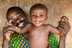 Proud father Koffi Morofie, 42, holds his youngest child. The boy, Anaste, is only 7 months old. His siblings are at school. They live in the village of Teko, in central Côte d'Ivoire. Proud father Koffi Morofie, 42, holds his youngest child. The boy, Anaste, is only 7 months old. His siblings are at school. They live in the village of Teko, in central Côte d'Ivoire.