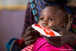 Gemechu Teteche, two years old, feeds on RUTF. Gemechu have come with his mother to the village health post for the weekly Outpatient Therapeutic Feeding Programme implemented by the village health extension worker with RUTF supplies provided by UNICEF with ECHO support. ©UNICEF Ethiopia/2017/Zerihun Sewunet