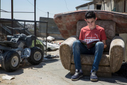 On 12 July 2018 in the State of Palestine, 14-year old Marwan sits on the roof of his house to study in the H2 area of Hebron. The space provides quiet and calm for Marwan, which is hard to come by inside or out of his home. He lives with his parents, five siblings, seven members of his uncle’s family and another family of three. Marwan’s hectic home is in Hebron’s old city, part of what is known as the H2 area, where around 40,000 of the city’s quarter of a million population live. The H2 area is punctuated by security checkpoints that Marwan and his peers must navigate to reach their classrooms. Delays in letting children pass, harassment and abuse by security forces and settlers are all part of the twice daily journey. In July 2018, almost all Palestinian children, between the ages of six and nine, are in school, but by age 15, nearly 25 per cent of boys have dropped out, according to the ‘State of Palestine: Country Report on Out-of-School Children’. The report, from UNICEF in the State of Palestine and the UNESCO Institute of Statistics, in cooperation with the Ministry of Education and Higher Education (MoEHE), highlights the multiple and often inter-related factors behind why children are out of school. This includes low quality education, that is often seen as not relevant to young lives, as well as poverty, physical and emotional violence in schools, including from teachers and peers, and armed conflict. The report highlights how better tailored education services, to meet the needs of individual students, particularly for those who fall behind, can help reduce drop out. This includes: flexible curriculum, different types of remedial learning opportunities and inclusive education for children with disabilities. Providing alternative education programmes outside of schools and improving the quality and reach of services that support the physical and emotional wellbeing of children are equally critical. In the Gaza Strip, classes are overcrow