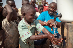 On 13 August 2018, Jean Marie Bofio, UNICEF’s WASH Officer, demonstrates to children how to correctly wash their hands in order to prevent the spread of Ebola near Mangina, North Kivu, the Democratic Republic of the Congo (DRC). “Children and women are among the first victims of the Ebola outbreak in the country. But there is hope and everything is done to stop Ebola. Water and sanitation are critical in this fight because hygiene is the best way to prevent the spread of the this deadly disease,” says Jean Marie Bofio. Following the 1 August 2018 announcement by the Government of the Democratic Republic of the Congo (DRC) of a new Ebola Virus Disease (EVD) outbreak in North Kivu, UNICEF has mobilized its teams to help contain the spread of the disease and protect children.  The impact of an outbreak on children can be far reaching. It’s known from earlier outbreaks in the DRC as well as in West Africa that children can be affected in various ways. Children can themselves be infected by the disease, but the impact goes beyond; it impacts their families and communities as children can lose their parents, care-givers and teachers. Access to basic services such as health care and education can become severely compromised. Also, children who are infected or whose relatives are, face stigmatization and social exclusion.  The Congolese Government has activated its response plan and called its partners, including UNICEF, to participate in the response. UNICEF has deployed a team to Beni for the response, including health specialists, communication specialists and a water, sanitation and hygiene specialist from the Ebola-response team in the Province of Equateur. Health, water, sanitation and hygiene and communication supplies have been sent to the affected areas including 300 laser thermometers to monitor the health conditions of people in the affected region and 2,000 kg of chlorine to treat water to help contain the spread of the disease. As at 14 August 2018,