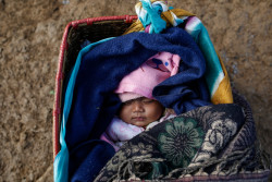 On 17 January 2016, a four month old baby boy born to Nepalese mother Sundari Gurung , aged 22, at her temporary shelter in Gupsi Pakha, in Laprak, in Gorkha district, Nepal. Both Sundari and her farther-in-law lost their homes during April 2015 earthquake and have been living in Earthquake Camp in Gupsipakha. The ongoing winter season and top of snowfall have been affecting her child, says Sundari. Laprak is one of the epicenter villages of Gorkha district, where more than 600 hundreds houses were destroyed during earthquake on 25 April 2015. Hundreds of earthquake victims, particularly the elderly and young children living in shelter of highland altitude have been facing a harsh winter season after snowfall.