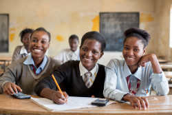 On 21 November, adolescent girls, including one taking notes, smile during a class, in Kamulanga Secondary School in Lusaka, the capital. In November 2016 in Zambia, the Government continues to make progress in improving education quality. However, challenges remain. Despite near-universal primary education in the country, more than 700,000 school-age children are still out of school. Critical groups include adolescent girls and children with special educational needs. UNICEF and partners are supporting national efforts to improve access to and quality of education in pre-primary, primary and secondary schools, including activities to increase education access for adolescent girls and marginalized children. UNICEF is also providing teaching and learning materials to promote quality education in community schools.