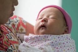 Angalan Maternity Hospital, Ulaanbaatar, Mongolia - September 05, 2018: Mother carries newborn baby in Angalan Maternity Hospital, Ulaanbaatar, Mongolia.