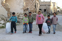 The children walk back home after choosing their new winter clothes through the UNICEF-supported e-voucher programme. 22 January 2019 in the Syrian Arab Republic. As of 30 January 2019, with dropping temperatures, children and their families across Syria are left with nothing to fend off the cold. Families living in collective shelters for the internally displaced or those returning to their destroyed homes amid a severe lack of services are especially vulnerable. Years of violence, displacement, lost livelihoods and depletion of financial resources have left them unable to provide for their children’s most basic needs, including winter clothes. To help ease the financial burden on families, UNICEF launched the innovative e-voucher programme, providing families with smart electronic cards charged with varying amounts of money based on the number of children and their ages. The vouchers are redeemable at pre-selected shops. The cards allow families to purchase full sets of winter clothes for their children, including a jacket, a woolen sweater, a thermal outfit, a pair of trousers, a woolen hat, scarf, gloves, socks and a pair of winter boots. The programme not only gives parents flexibility in choosing products, but also maintains their dignity and empowers the local economy by creating demand. In Aleppo, with thanks to the Department of International Development (DFID), the programme aims to reach 12,000 children under the age of 15 in eight war-ravaged neighbourhoods of the city with e-vouchers, redeemable at 24 shops. Hameed, the father of 8 children; Ghada, 12, Ahmed, 10, twins Rana and Ali, 8, twins Rasha and Zakaria, 6, Mohammad, 3, and Fatima, 1, was happy to accompany his children to buy winter clothes, using the UNICEF-provided e-vouchers in the city of Aleppo. “Last month, Ahmed’s old trainers finally gave up and were torn apart, forcing him to walk barefoot!” says Hameed who works as a day laborer. “I bought him another pair from a second-