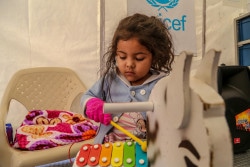 コロンビアに設置されたユニセフの子どもにやさしい空間で、木琴で遊ぶ4歳のヴァレリーちゃん。