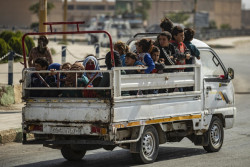 On 11 October 2019 in the Syrian Arab Republic, women and children are transported on the back of a truck as families displaced from Ras Al-ain arrive in Tal Tamer, 75km southeast Ras of Al-ain, having fled escalating violence. In early October 2019, as violence escalates in northeast Syria, many children are at imminent risk of injury, death and displacement. of Ras al-Ain and Tal Abiad. Since the start of the hostilities on 9 October 2019, an estimated 130,000 people have fled from areas around Tal Abiad and Ras Al-ain. Most of the 18,000 people living in Tal Abiad town and 11,000 people living in Ras Al-ain have reportedly fled towards Tal Tamer and Hasakeh City. While most of the displaced are being hosted in the local communities with relatives, some have sought refuge in collective shelters in schools and unfinished buildings. An estimated 33 collective shelters have been identified. In Tal Tamer, 18 schools are hosting an increasing number of IDPs. While significant further displacements continue, UNICEF’s partners have started providing emergency assistance to families arriving at collective shelters in Hassakeh city and Tal Tamar.