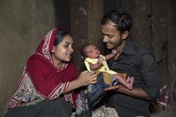 赤ちゃんをあやす両親。（バングラデシュ）