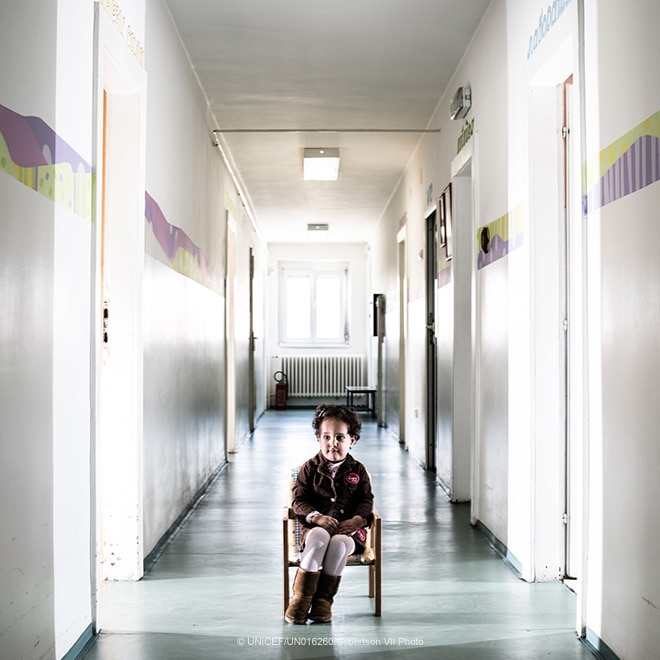 A young child in a hallway at a residential care facility, Serbia